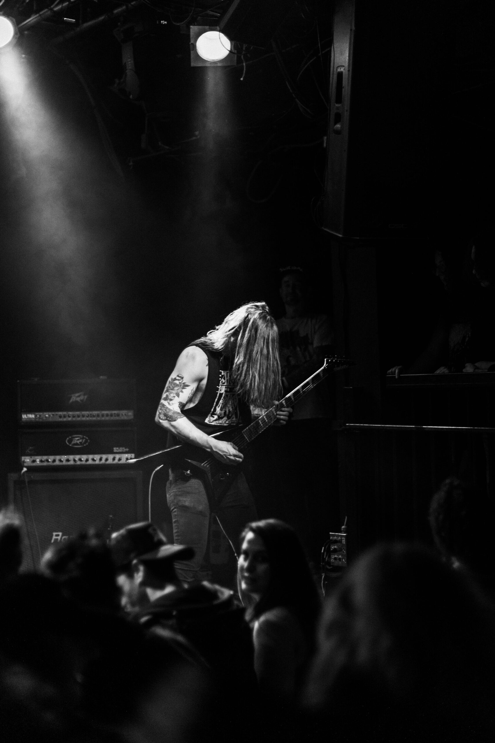 Grayscale Photo of Man Playing Guitar on Stage